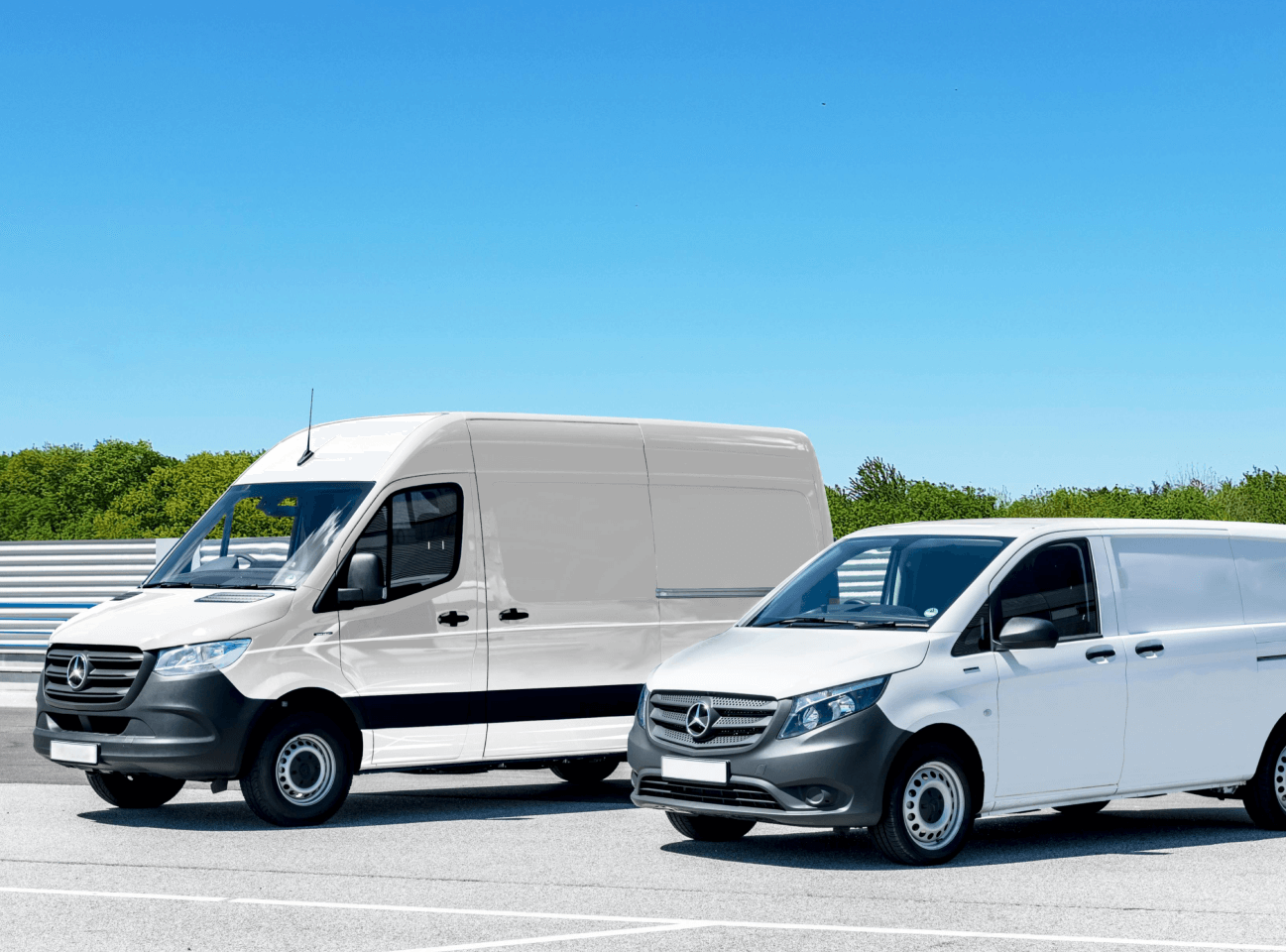 two mercedes white commercial vehicles